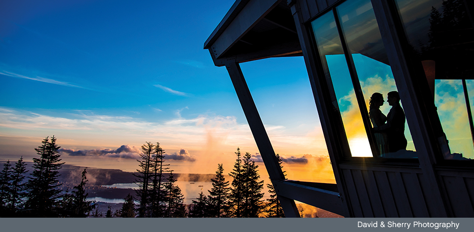 Married couple in the Observatory window at Sunset overlooking Vancouver